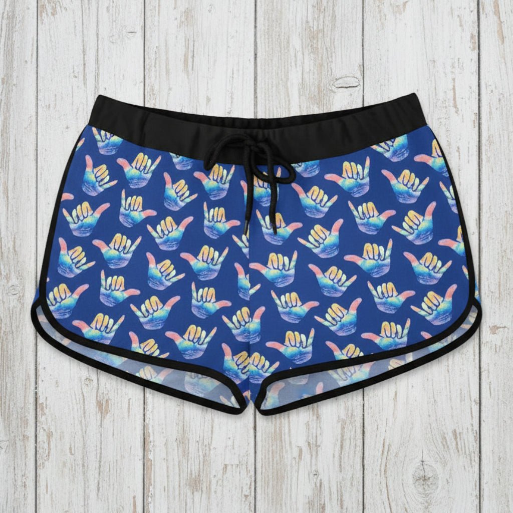 Blue patterned shaka shorts on a rustic wood background