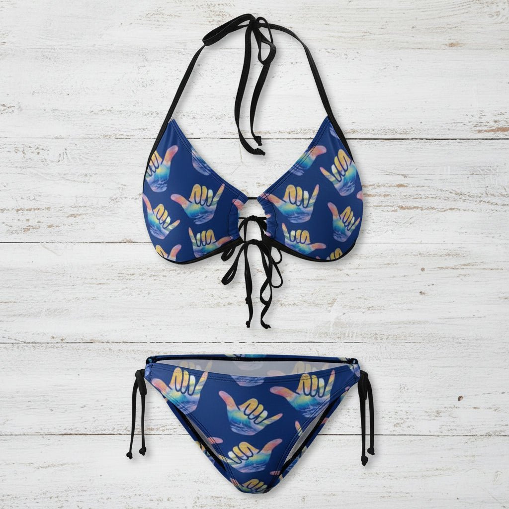 Blue bikini set with colorful shaka hand signs on a white nautical wood background