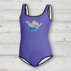 Purple swimsuit with a colorful wave design on a nautical wood background