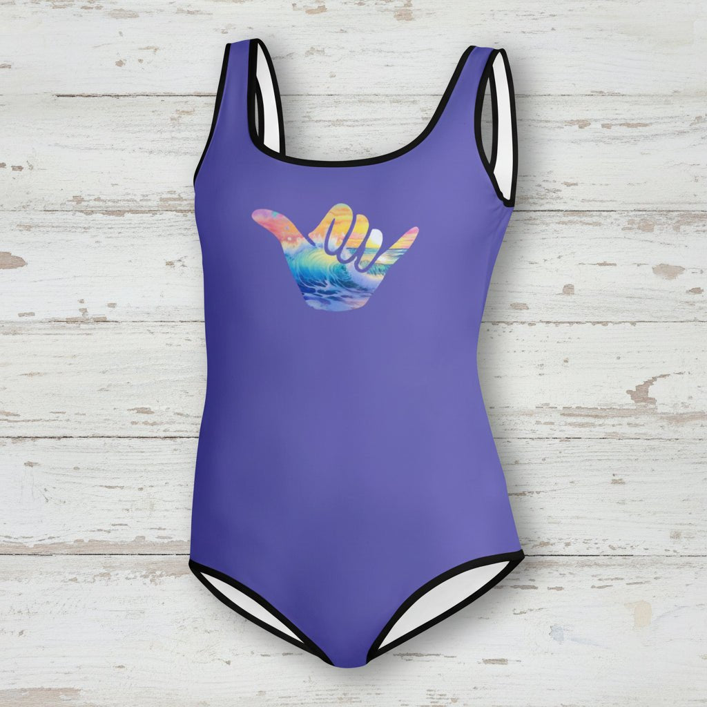 Purple swimsuit with a colorful wave design on a nautical wood background