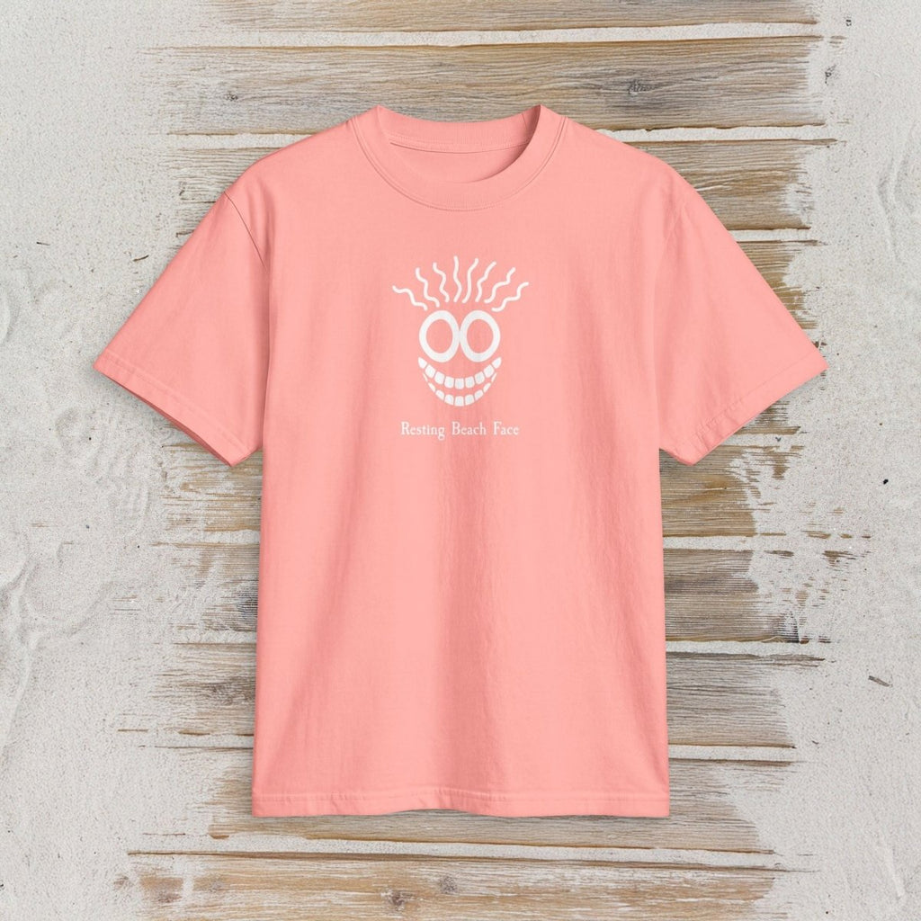 A coral pink short-sleeve t-shirt with a white graphic of a smiling face with smoke and the text 'Bustin' Back Four' on the chest, displayed flat on a rustic light gray wood plank background.