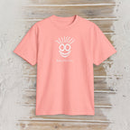 A coral pink short-sleeve t-shirt with a white graphic of a smiling face with smoke and the text 'Bustin' Back Four' on the chest, displayed flat on a rustic light gray wood plank background.