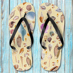 Pair of Shelling Flip Flops with shell pattern on a wooden surface
