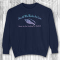 Navy blue sweatshirt with text and graphic on a wooden surface