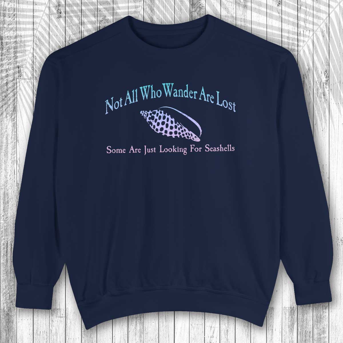 Navy blue sweatshirt with text and graphic on a wooden surface