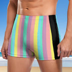 Multicolored striped swim shorts with a black patch on a beach background