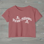 Pink t-shirt with 'Pirate Pillows' text and skull designs on a white background
