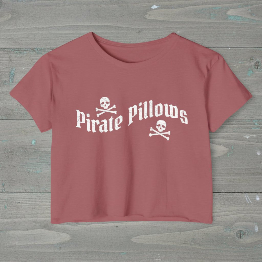 Pink t-shirt with 'Pirate Pillows' text and skull designs on a white background