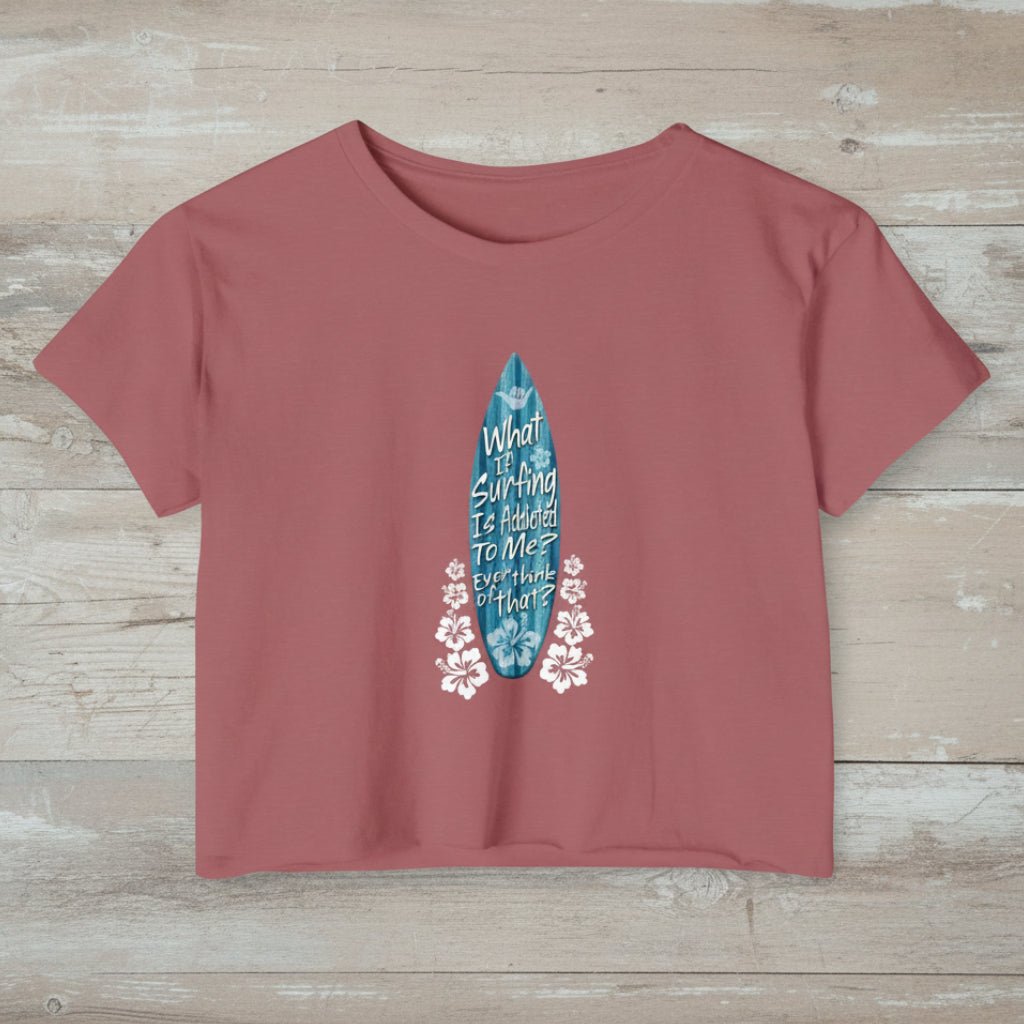 Smoked Paprika crop-top t-shirt with a blue surfboard graphic and text on rustic wood background
