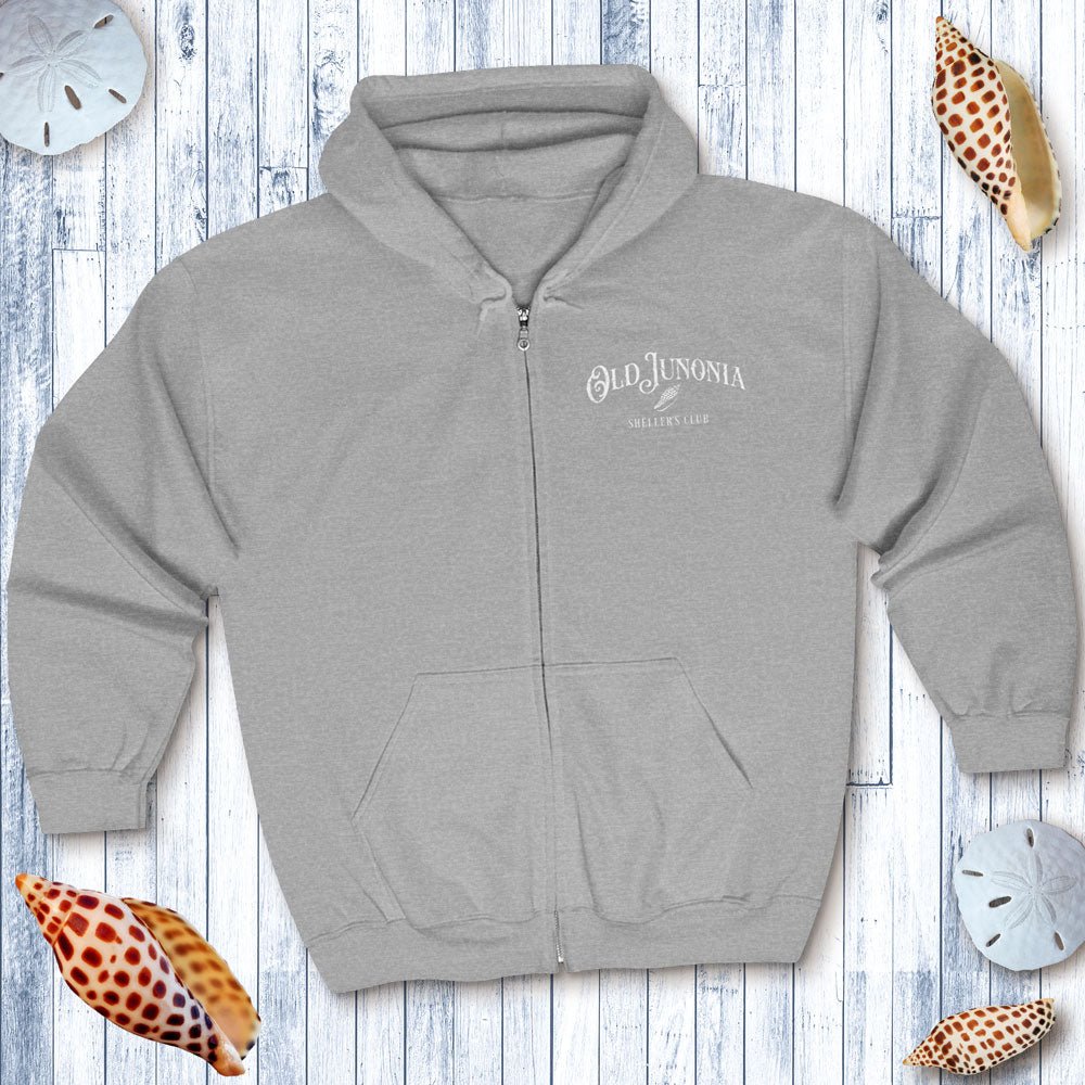 Gray zip hoodie with 'Old Junonia' logo on a wooden surface with decorative shells.