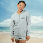 Person wearing a gray hoodie with text on a beach
