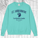 A mint green crewneck sweatshirt with a dark blue graphic print on the front reading 'ST. SOMEWHERE Caribbean Islands Where It's Warm Since 149' with an eagle head illustration, displayed flat against a white wood plank background.