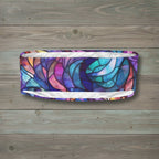 Multicolored headband with a stained glass design on a rustic wood background