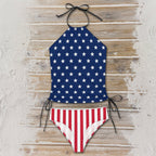 Bikini set with star-patterned top and striped bottom on a beachside boardwalk surface