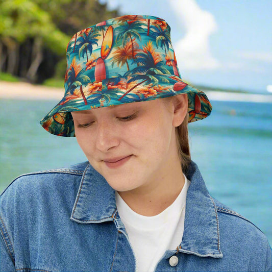 Surfer Girl wearing a Bongo Beachwear Bucket Hat with Cool Hawaiian Style Surfboard pattern. standing on the beach in Hawaii