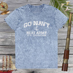 Blue t-shirt with 'Go Navy, Beat Army, It's Tradition' text on a wooden background with nautical items.