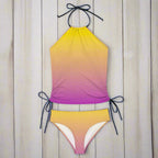 Gradient yellow to purple bikini set with black straps on a rustic nautical  background