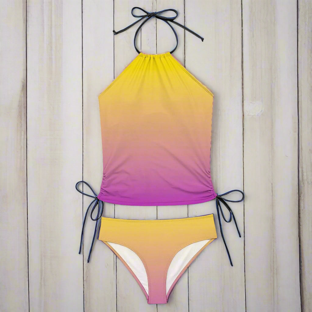 Gradient yellow to purple bikini set with black straps on a rustic nautical  background