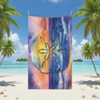 Colorful towel with sand dollar design on a tropical beach background