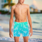 Young Dude wearing blue swim shorts with shark pattern on the beach in Key West