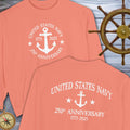 Coral t-shirt with 'United States Navy 250th Anniversary' design, displayed with a ship's wheel and compass.