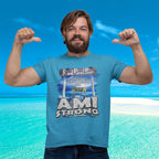 Man wearing a 'AMI Strong' t-shirt with a beach background
