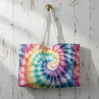 Tie-dye tote bag with a spiral pattern hanging on a wooden wall.