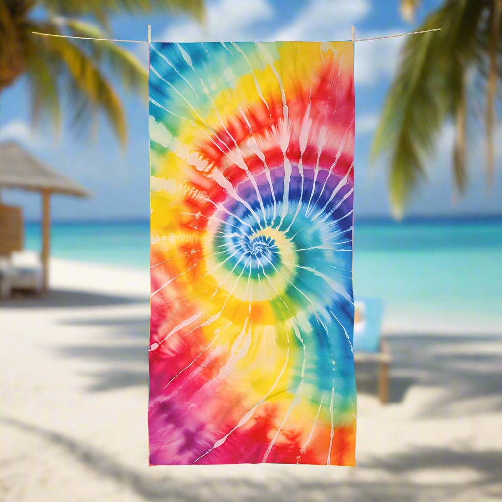 Classic Spiral tie-dye beach towel hanging on a line is a tropical paradise