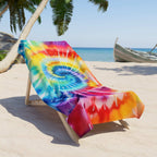 Classic Spiral tie dye beach towel on a beach lounger under a palm tree at the beach