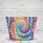 Tie-dye patterned bag with a rope handle on a rustic wood background