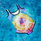 Tie-dye swimsuit on a blue tiled pool floor