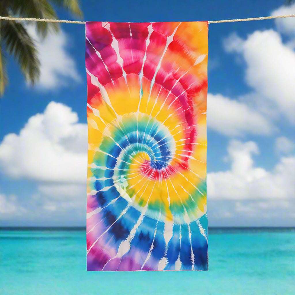 Cool Spiral Tie-Dye Beach towel with silhouette of surfer riding the spiral wave handing on a line in a tropical paradise