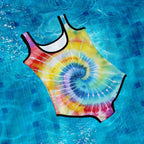 Tie-dye swimsuit on a blue tiled pool floor