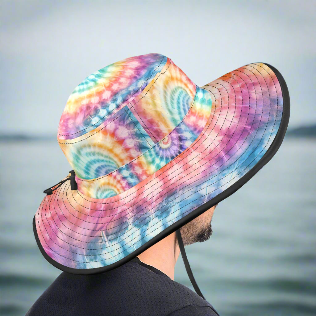 Colorful tie-dye bucket hat worn by a guy fishing off a pier.