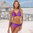Woman wearing a purple and pink Tiger Stripes String Bikini print on a beach.