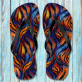 Pair of Tiger Print Flip Flops with a tiger stripe pattern on a wooden surface