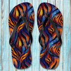 Pair of Tiger Print Flip Flops with a tiger stripe pattern on a wooden surface
