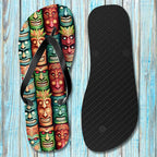 Flip-flop with colorful tiki mask design on a wooden surface