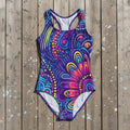Colorful patterned swimsuit on a rustic wood background