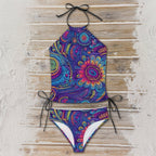 Colorful paisley-patterned bikini set on a wooden surface