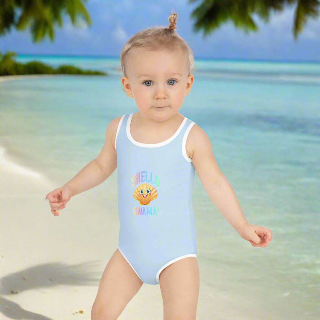 Girl's Sky Blue Toddler One Piece Swimsuit saying SHello' Gwama' worn by cute little girl on the beach 