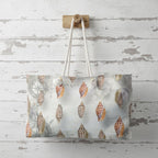 Tote bag with shell pattern hanging on a wooden hook against a rustic wooden wall.