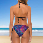 Woman wearing a colorful bikini with a beach background