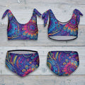 Colorful bikini set with a paisley pattern on a rustic nautical wood background