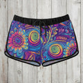 Colorful tribal patterned shorts on a wooden surface