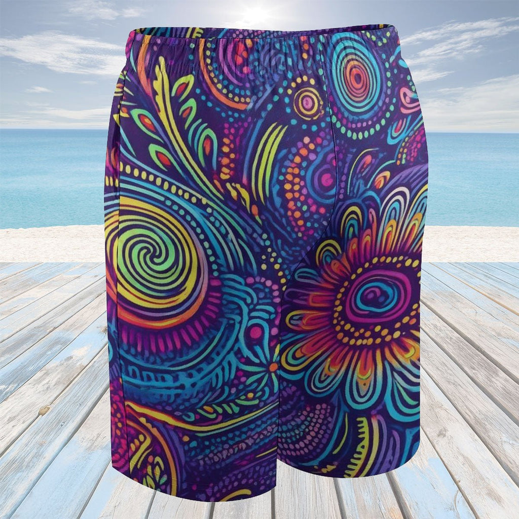 Colorful patterned shorts on a wooden deck with a beach background