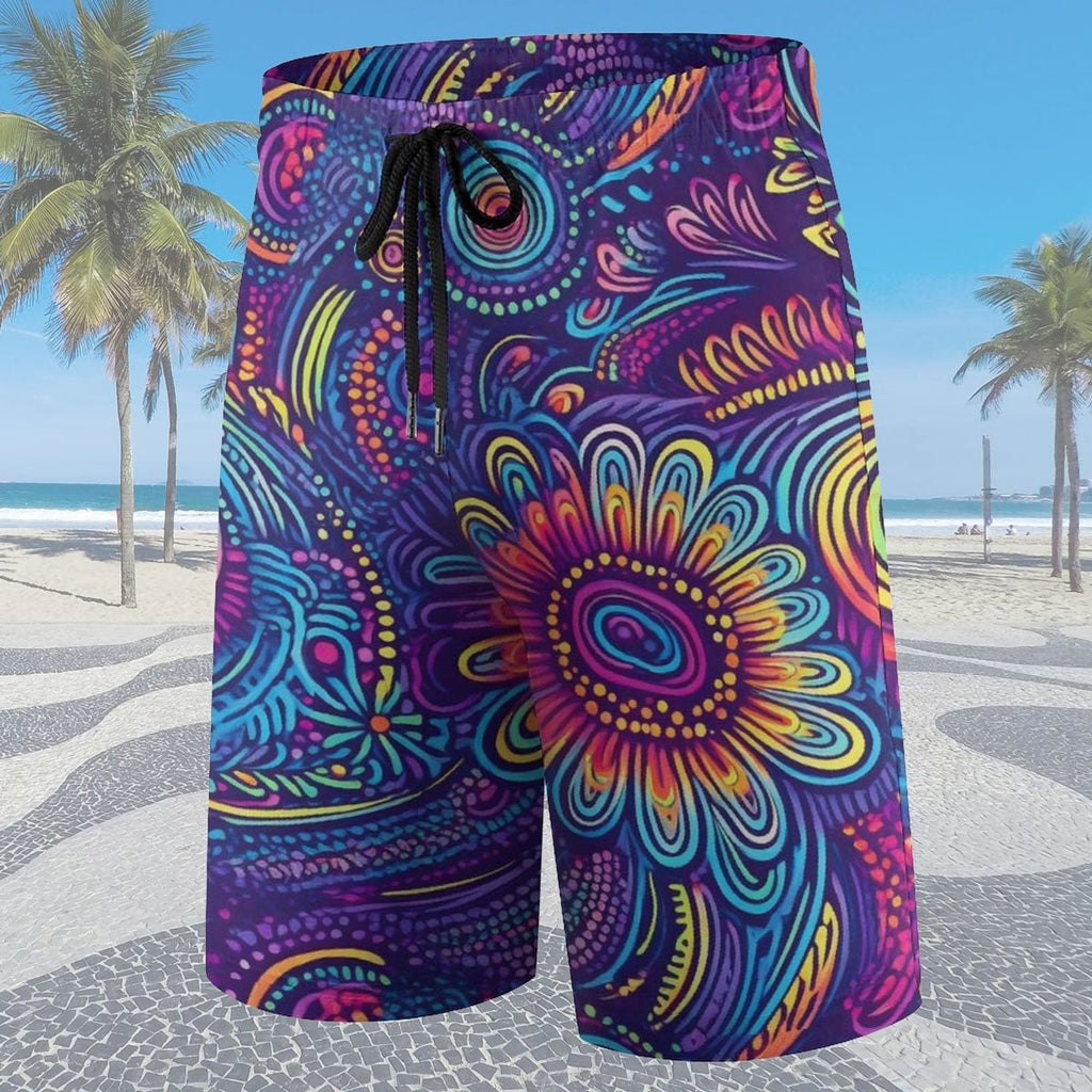 Colorful patterned shorts on a beach with palm trees and blue sky.