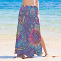 Person wearing a colorful tiki island  patterned sarong wrap on a beach