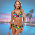 Woman wearing a colorful String Bikini set with a pool and palm trees in the background