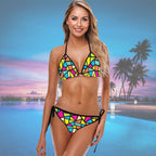 Woman wearing a colorful String Bikini set with a pool and palm trees in the background